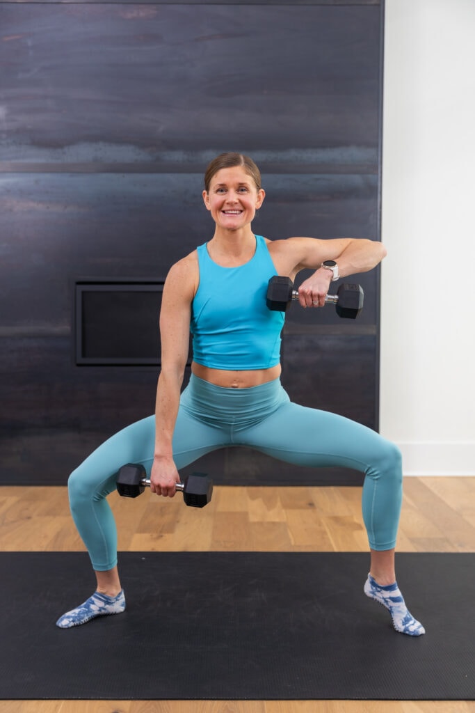 woman performing a plie with a heel lift as example of barre exercises at home