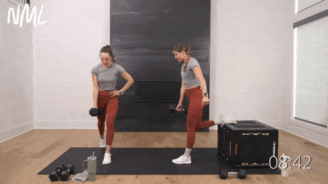 one woman performing a rear foot elevated split squat and one woman performing split squats in a leg workout
