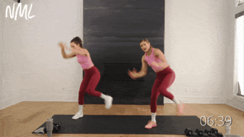 two women performing standing crunches as part of walking workout