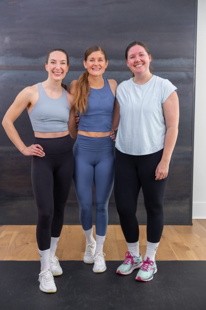 Three women posing after completing dumbbell workout rinte