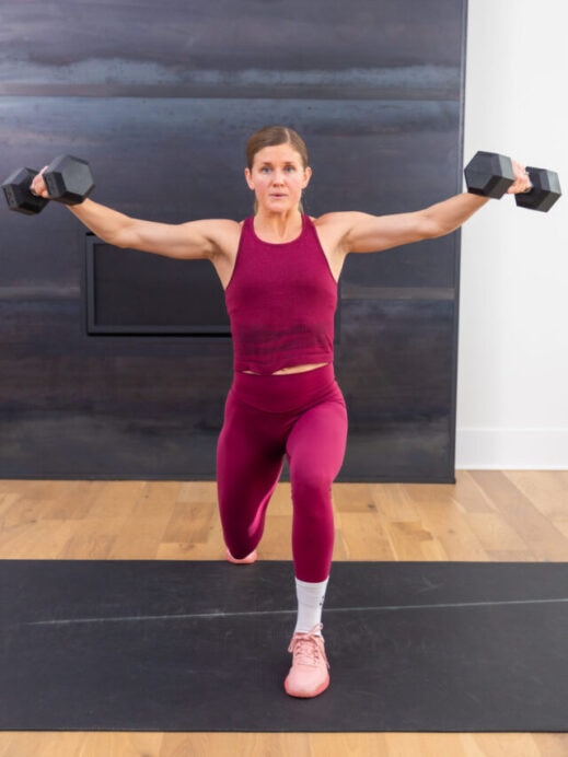 woman performing a reverse lunge and lateral raise with dumbbells in a full body workout
