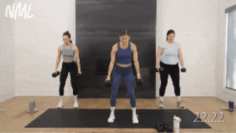 three women performing a dumbbell squat, clean and press as part of dumbbell workout routine