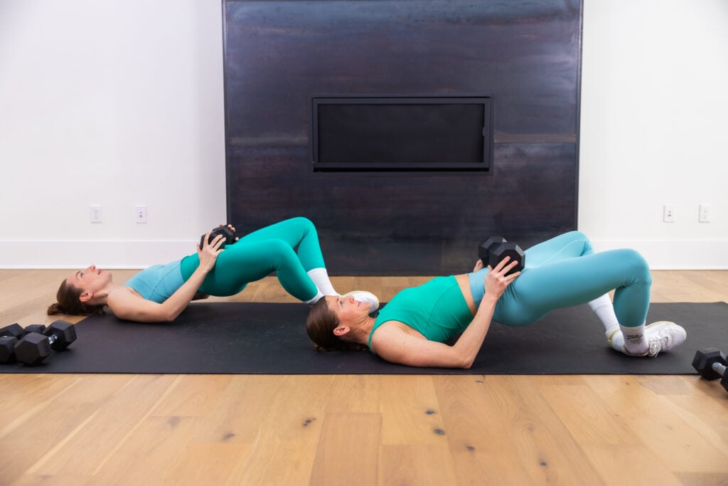 two women performing froggy glute bridges or frog pumps as example of dumbbell leg exercises
