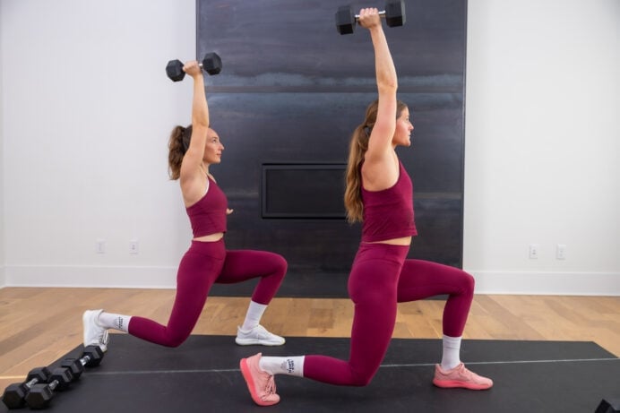 two women performing a lunge and shoulder press as part of dumbbell workout