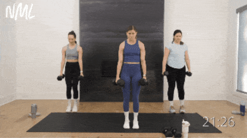 three women performing alternating reverse lunges as part of dumbbell workout routine