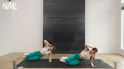 two women performing a modified side plank lift and hold in a beginner workout routine