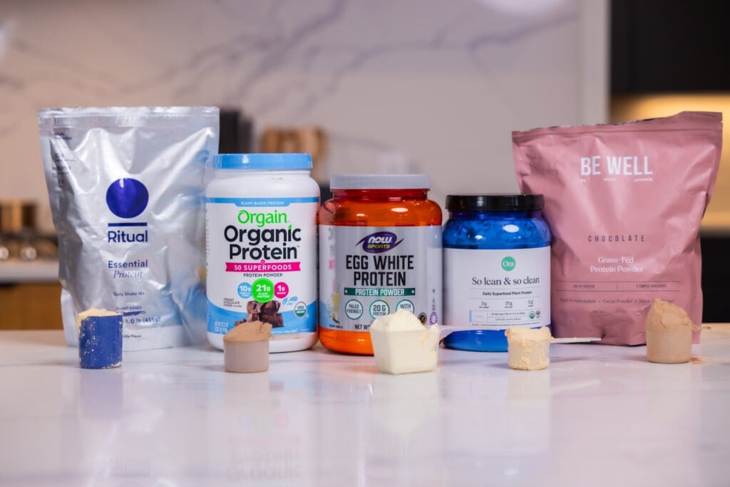 Protein powders including BeWell Grass-fed protein powder, orgain organic protein powder, ora so lean and so clean protein powder, now foods egg white protein powder, ritual essentials protein