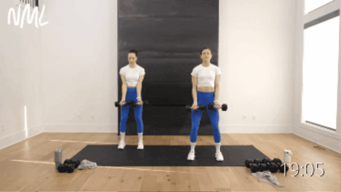 two women performing lateral shoulder raises as example of best dumbbell arm exercises