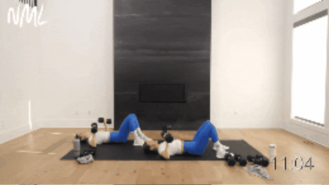 two women performing dumbbell chest press exercise as example of dumbbell arm exercises