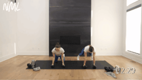 two women performing a push up, plank and dumbbell row as example of best dumbbell exercises