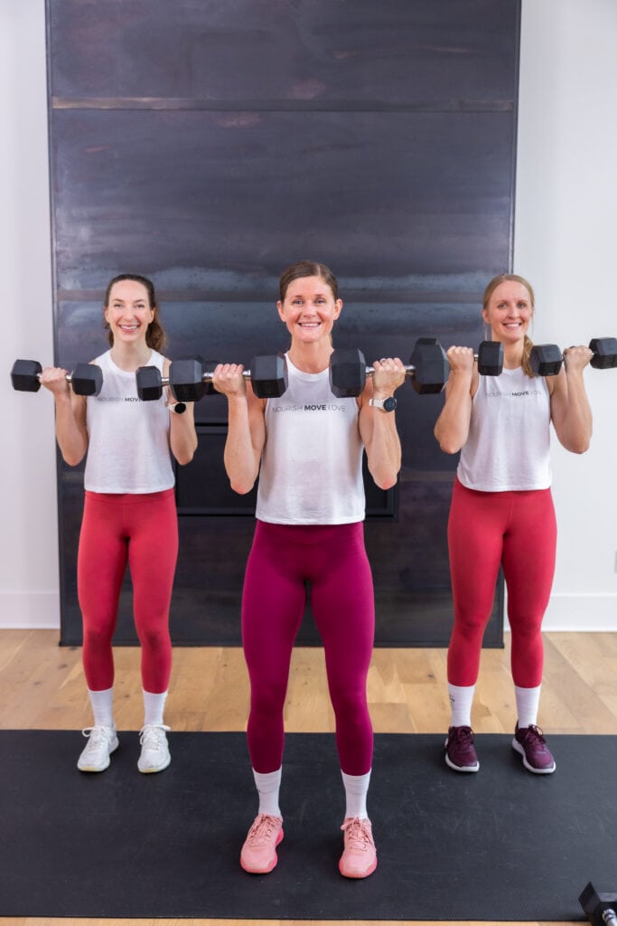 three women performing a bicep curl as example of best strength and hiit exercises for women