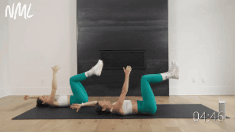 two women performing a deadbug as example of upper ab workout