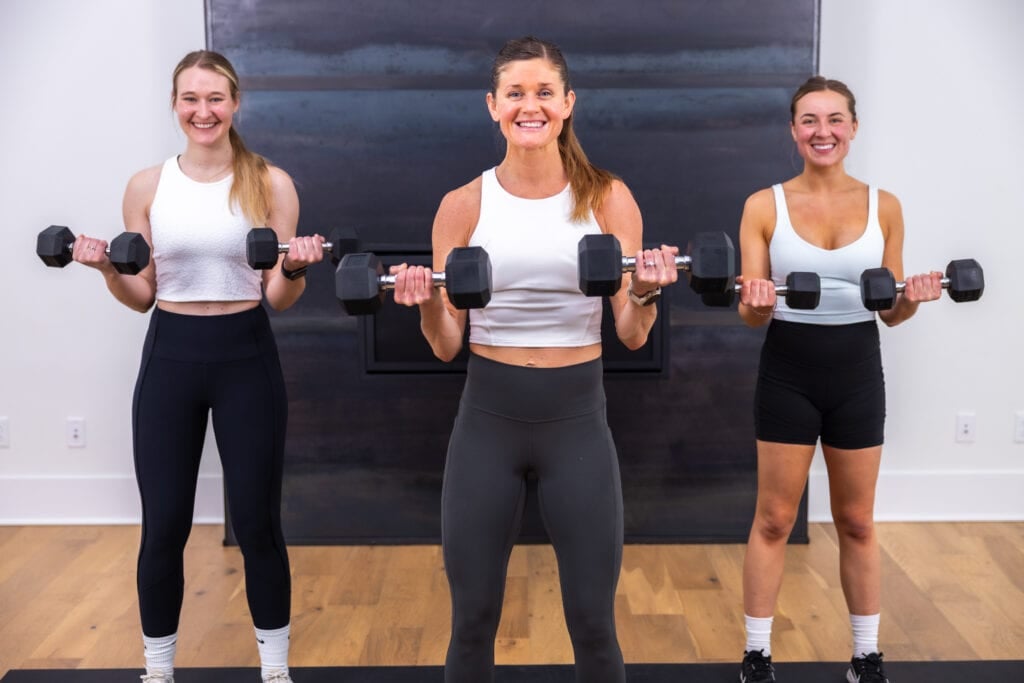 three women performing a bicep curl as part of strong arms workout