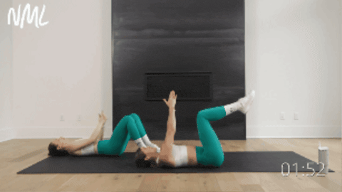 two women performing table top heel reaches as part of upper abs workout