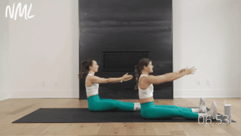 two women performing pilates roll up as example of upper ab exercise