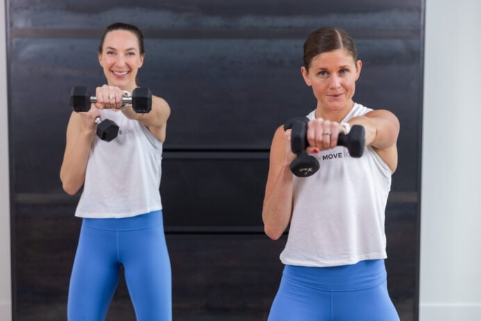 two women performing a crossbody punch as part of boxing workout at home