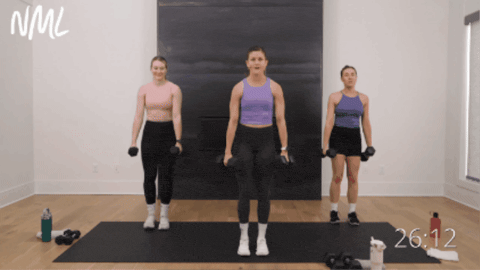 three women performing reverse lunges as part of strong legs workout