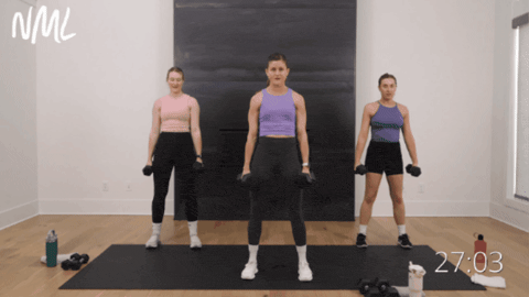 three women performing dumbbell squats as part of strong legs workout