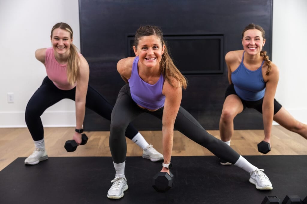 three women performing a lateral lunge as example of how to build strong legs
