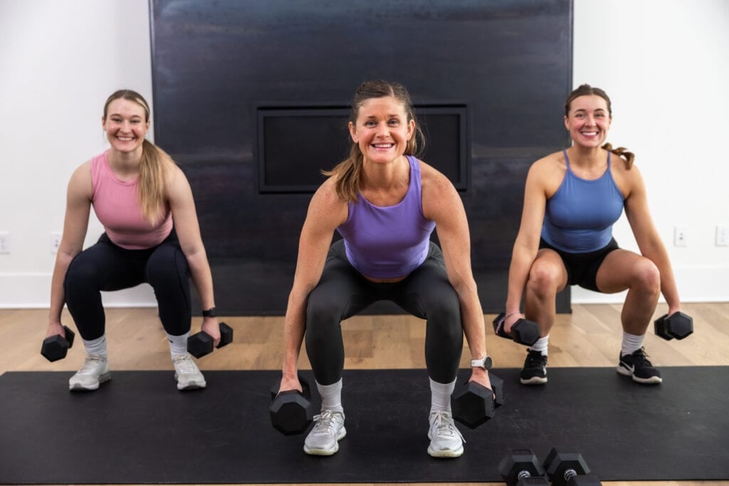 three women performing a squat as part of strong legs workout