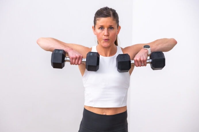 woman performing upright row as part of strong arms workout