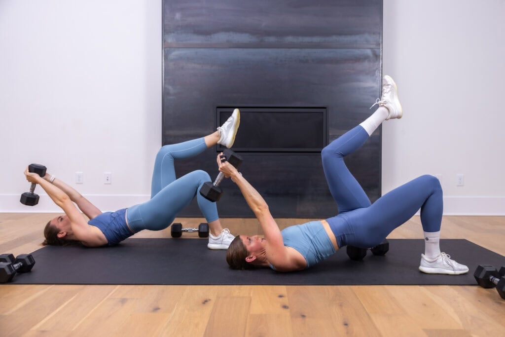 two women performing a dumbbell pullover as part of arm workout routine