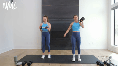 two women performing a reverse lunge and hammer curl