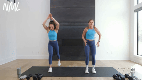two women performing lunge drops in a home workout