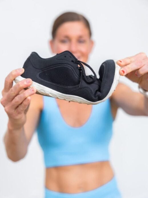 Women showing the bend in a pair of barefoot shoes for women.