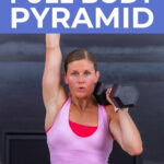 woman performing dumbbell shoulder press