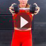 woman performing a dumbbell press out