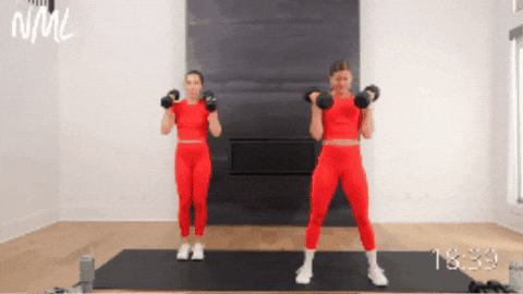 two women performing burpee cleans as part of hiit workout at home