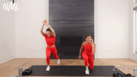 two women performing lunge and squat jumps as part of hiit workout at home