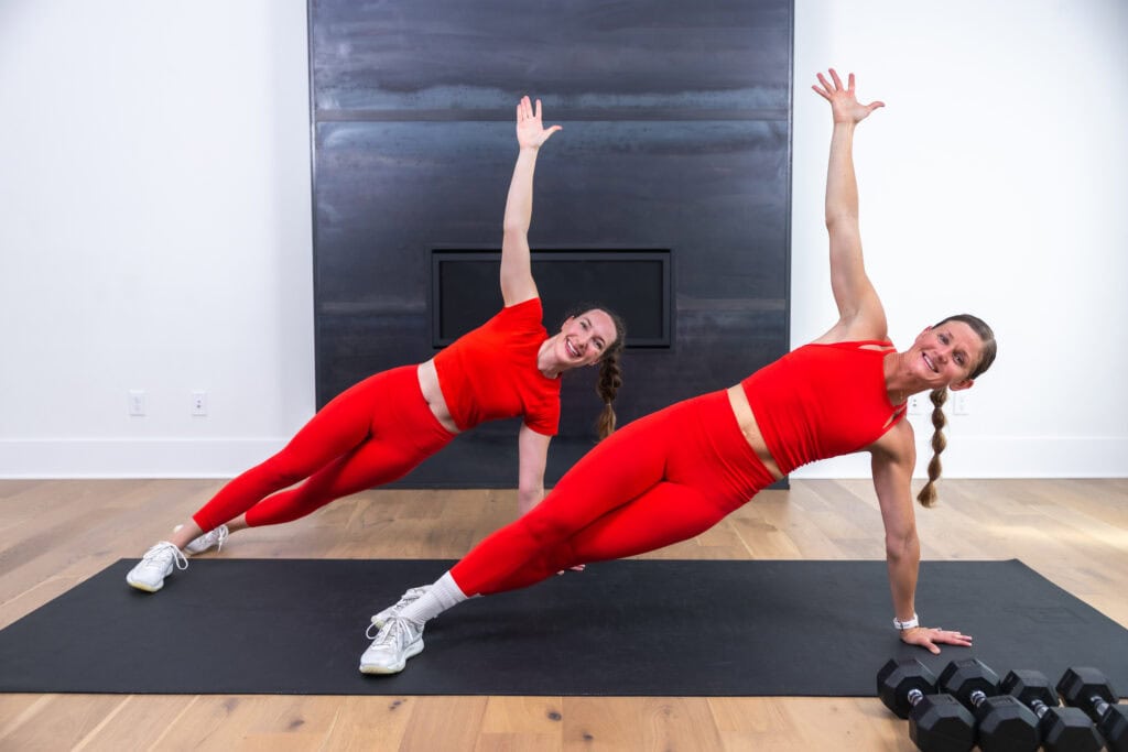 two women performing side plank as part of hiit workout at home