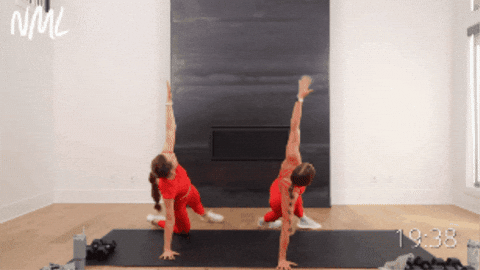 two women performing push ups as part of hiit workout at home