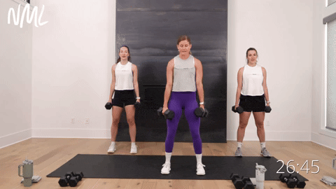 three women performing tempo goblet squats into a squat hold in a weight training workout