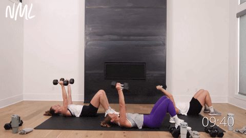 three women performing dumbbell skull crushers and chest flys in a full body weight training workout