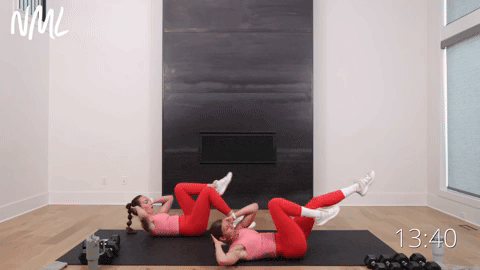 two women performing bicycle crunches in a full body home workout