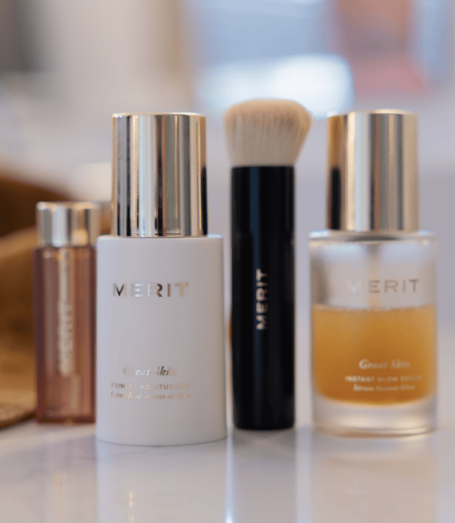 Merit Makeup with glow spray, brush and lip stick.