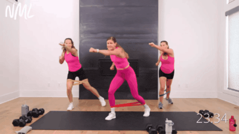 women wearing pink tank tops performing pregnancy-friendly cardio exercise
