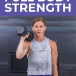 woman holding dumbbell at shoulder