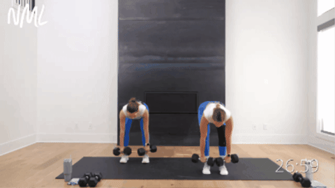 two women performing deadlifts, cleans and squats as example of dumbbell hiit training