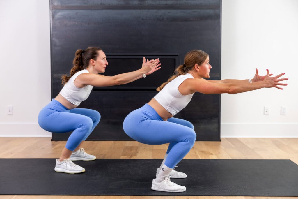 two women performing a jump squat as part of hiit training at home workout