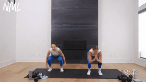 women performing jump squats as example of hiit exercises with no equipment