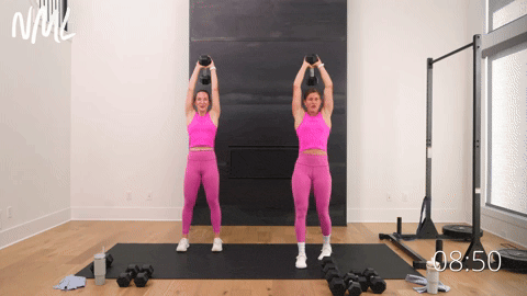 two women performing overhead tricep extensions in a full body weight training workout