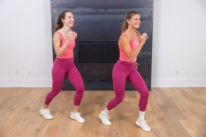 two women marching in place to get their steps in as part of an indoor walking workout