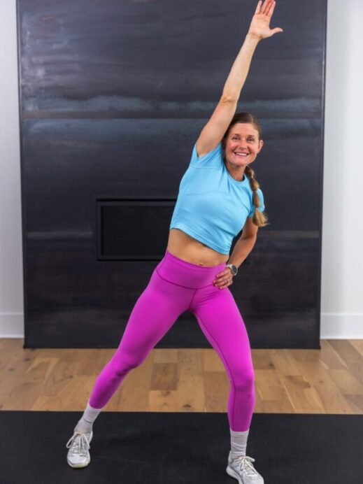 woman performing a standing knee pull in a hiit workout