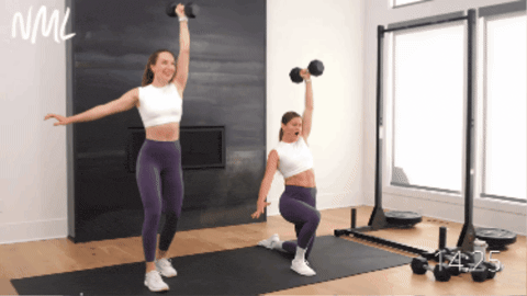 two women performing a half kneeling clean and single arm shoulder press