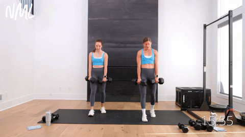 two women performing a staggered dumbbell deadlift in a full body workout
