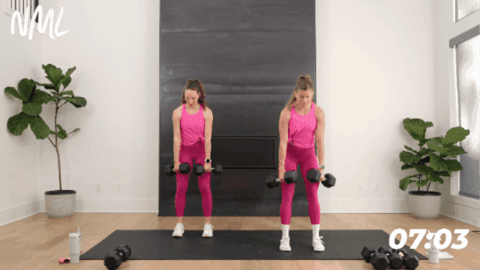 standing women performing romanian deadlifts with dumbbells
